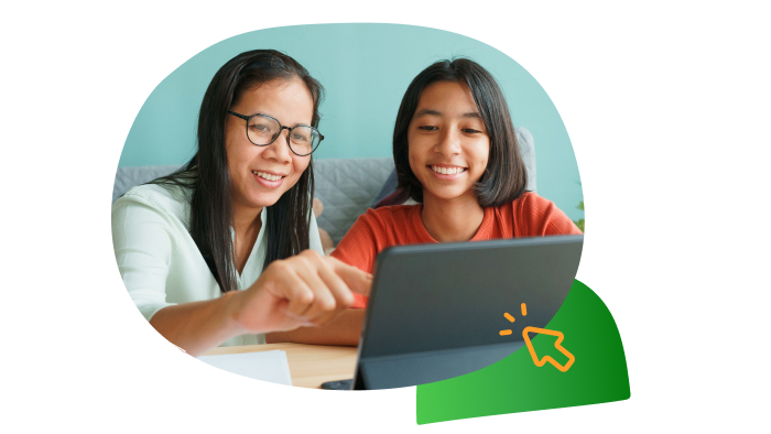 smiling female child and adult touching a tablet device